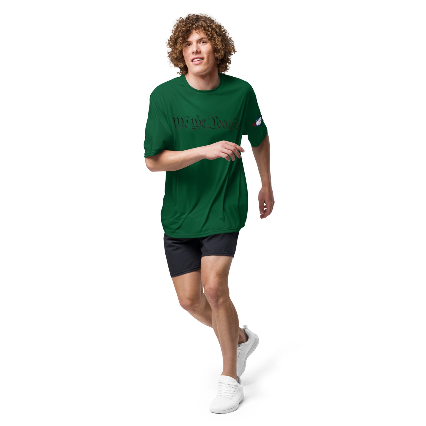 Curly-haired dude dashing in forest green "We The People" tee, flag patch, gym shorts