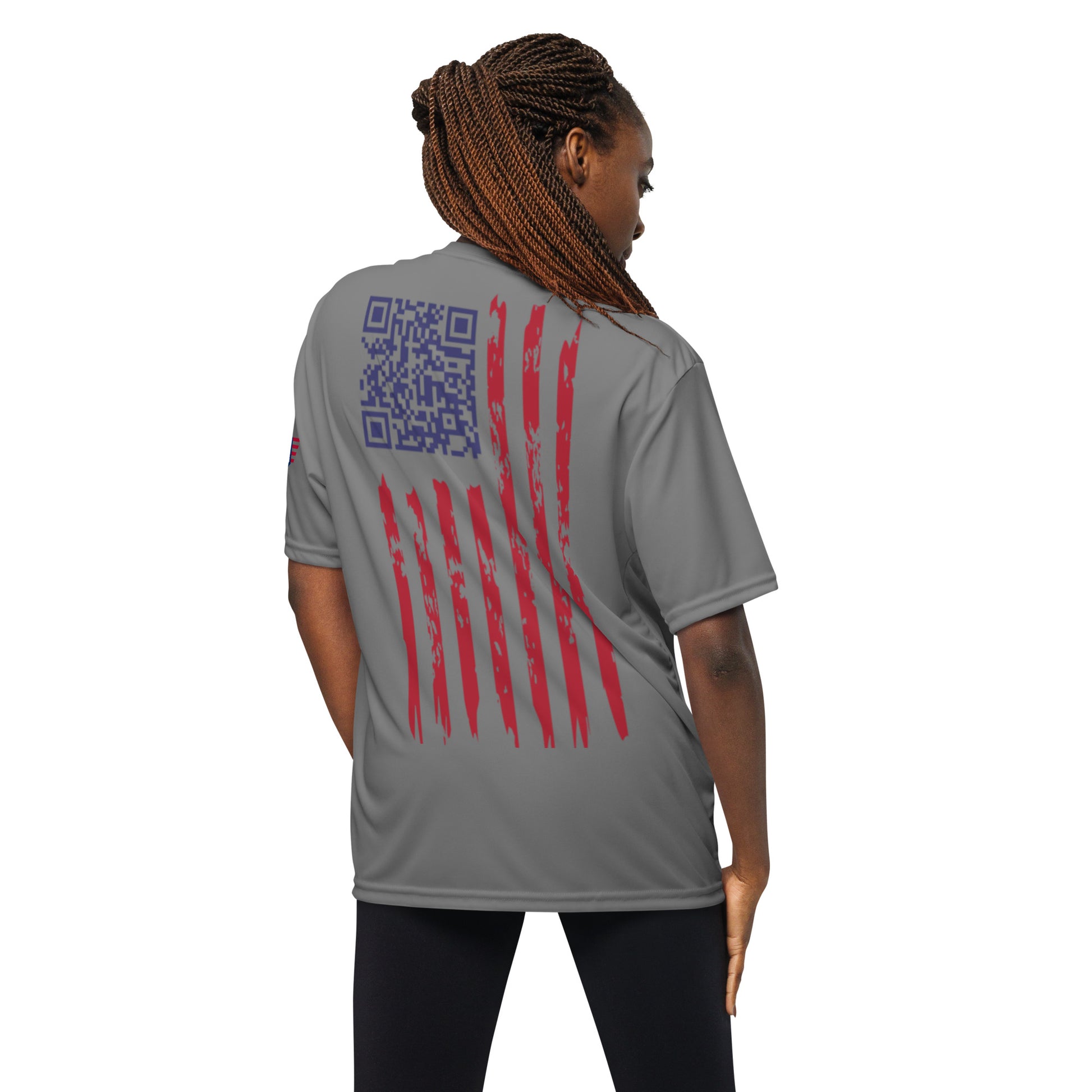 Back view of woman in graphite performance tee: navy QR code easter egg amid red striped flag vibes