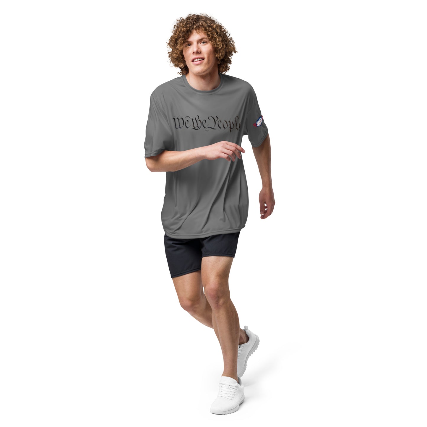 Guy running in graphite "We The People" unisex performance shirt, trail boss style
