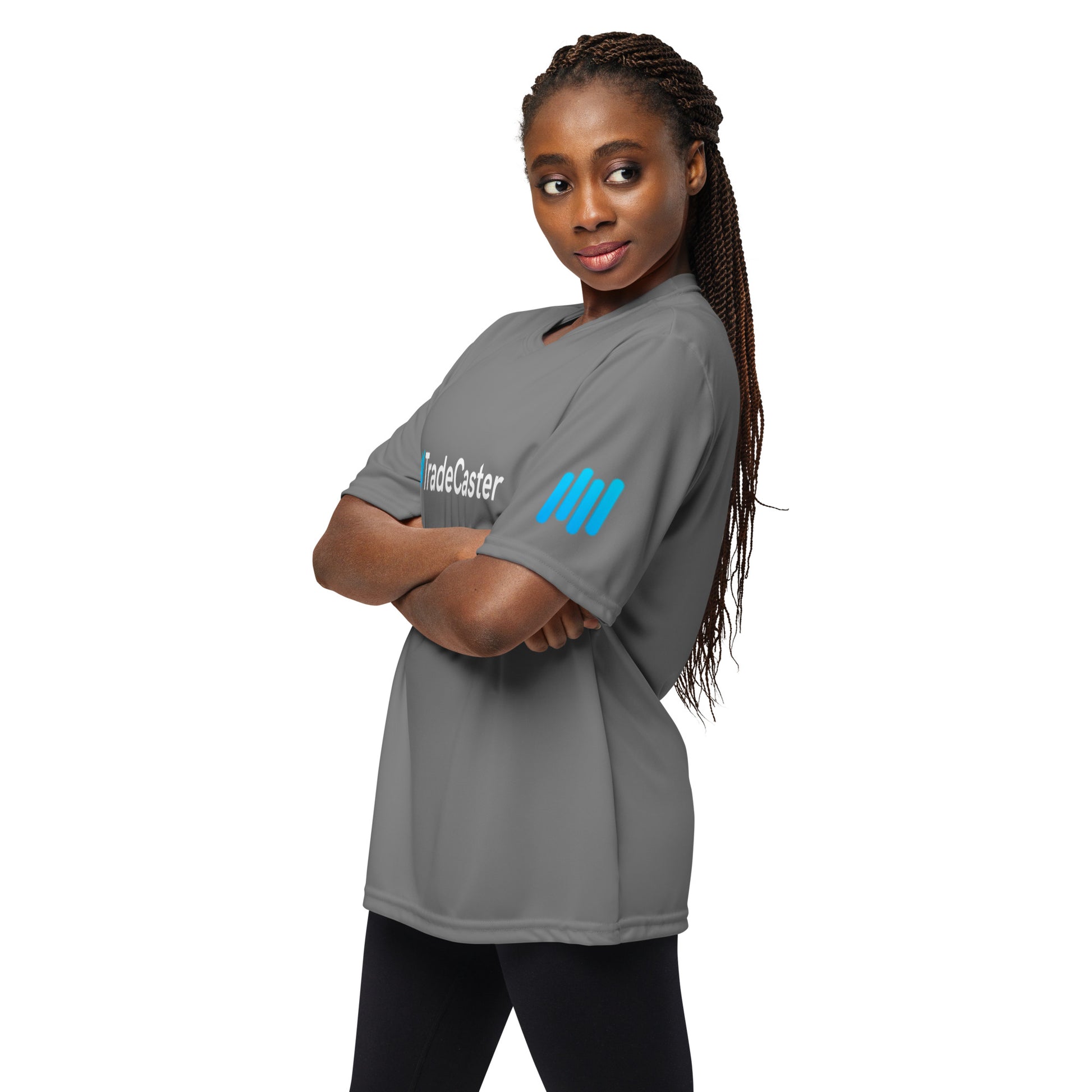 Woman poses sideways in graphite performance tee, cyan TradeCaster sleeve detail shines