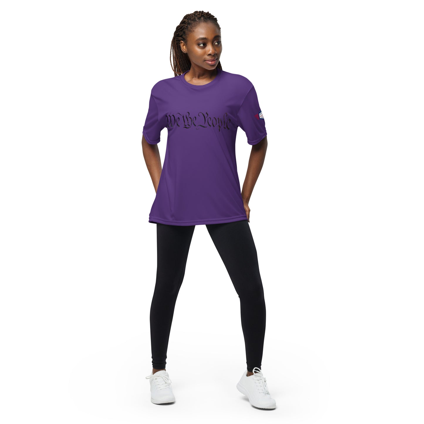 Woman posing in purple "We The People" performance crew tee front, colorful flag sleeve