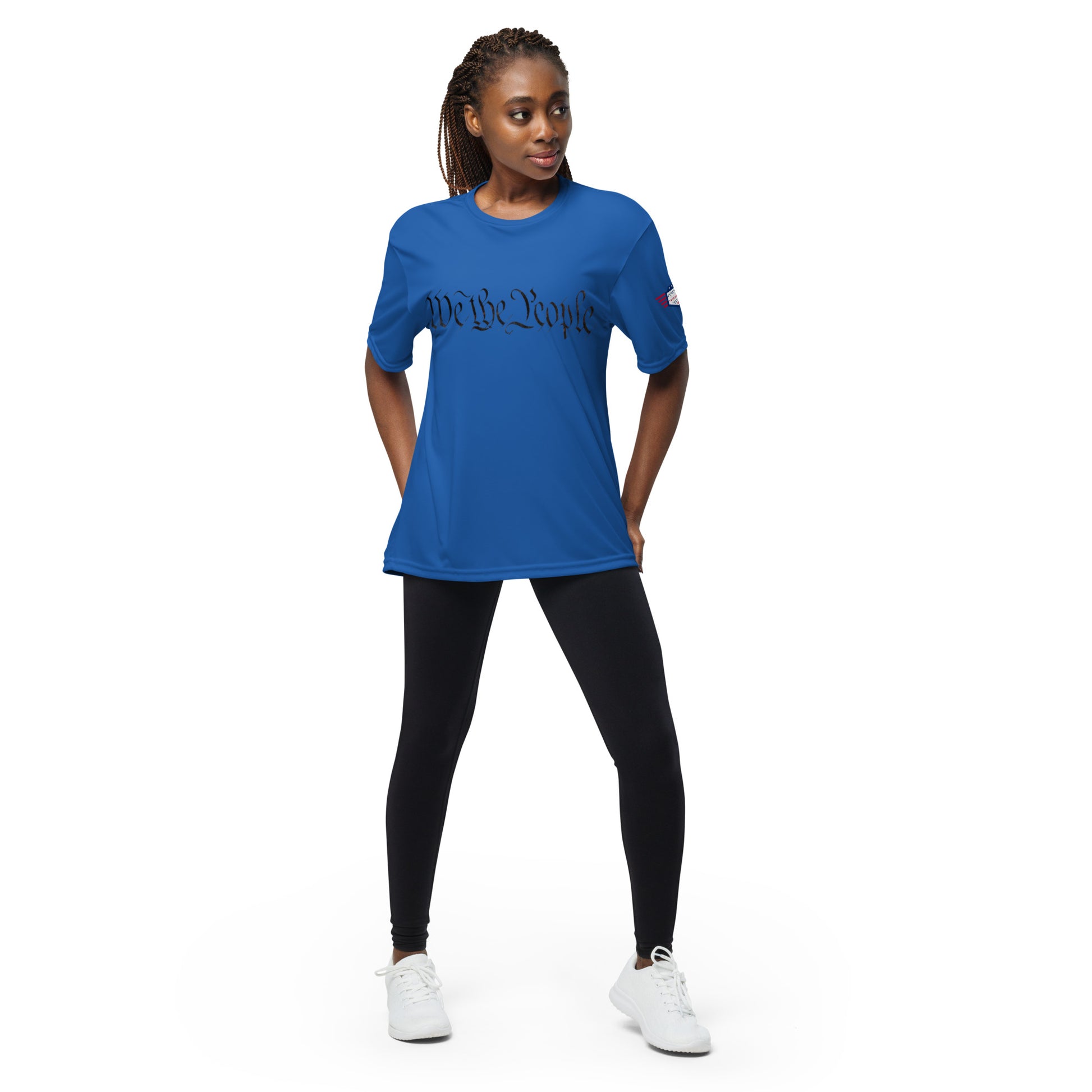Woman model in royal blue performance crew tee, "We The People" cursive front, flag sleeve patch