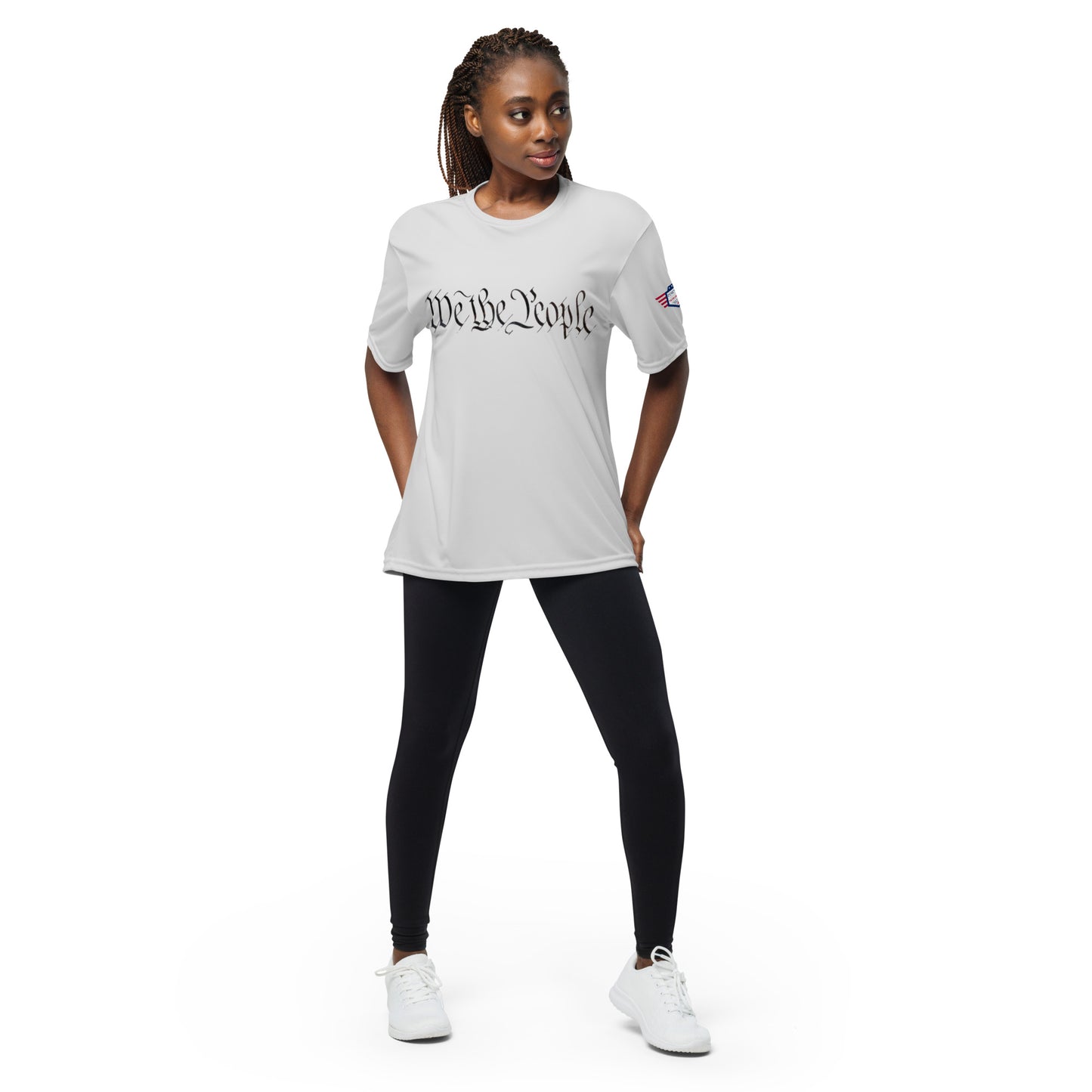 Woman posing in heather gray performance tee: crisp "We The People" text and tiny sleeve flag
