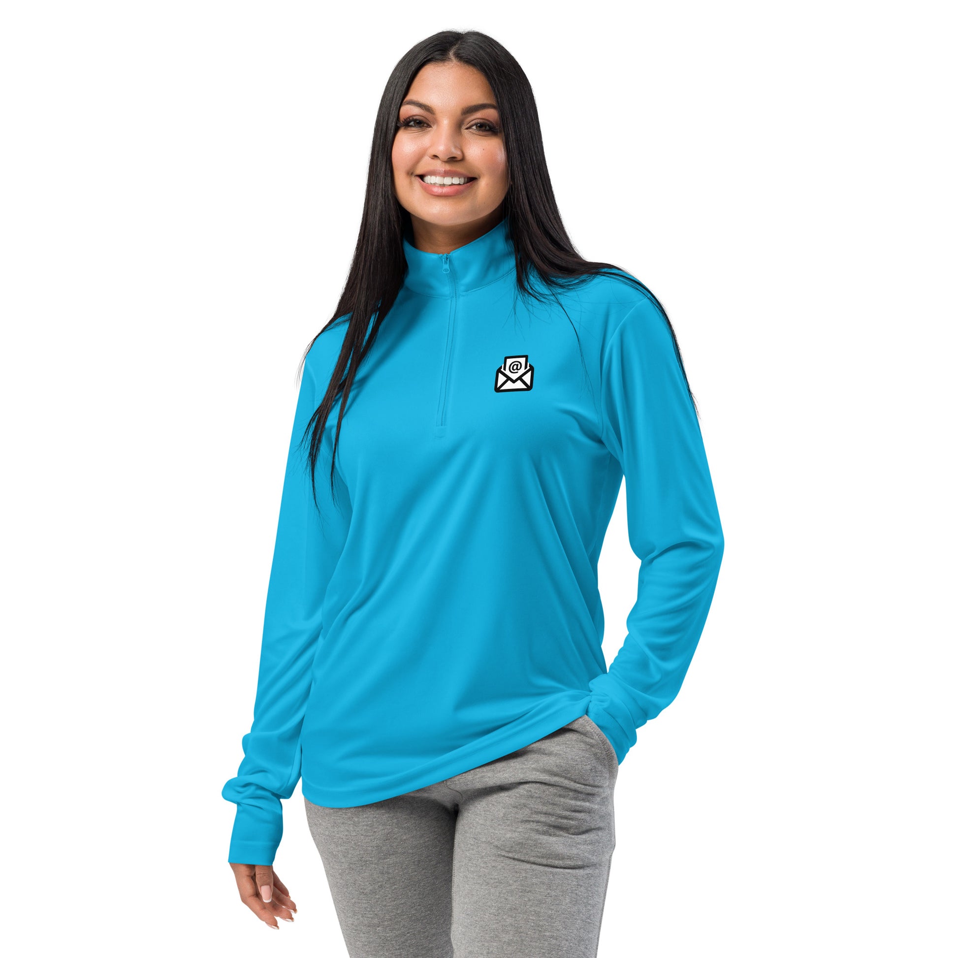 Smiling woman models front of bright blue quarter-zip with white envelope chest print