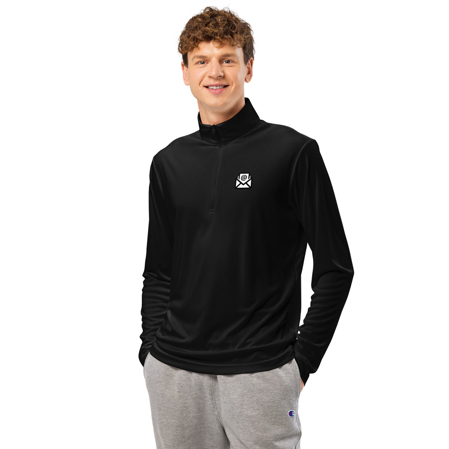 Smiling guy in black quarter-zip pullover, white envelope icon on chest—email vibes