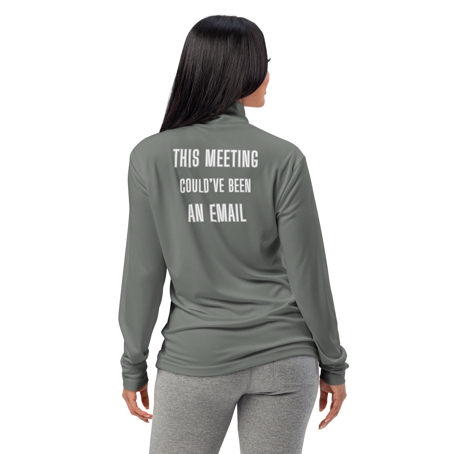 Back view on smiling woman in grey quarter-zip pullover with white "THIS MEETING COULD'VE BEEN AN EMAIL" text