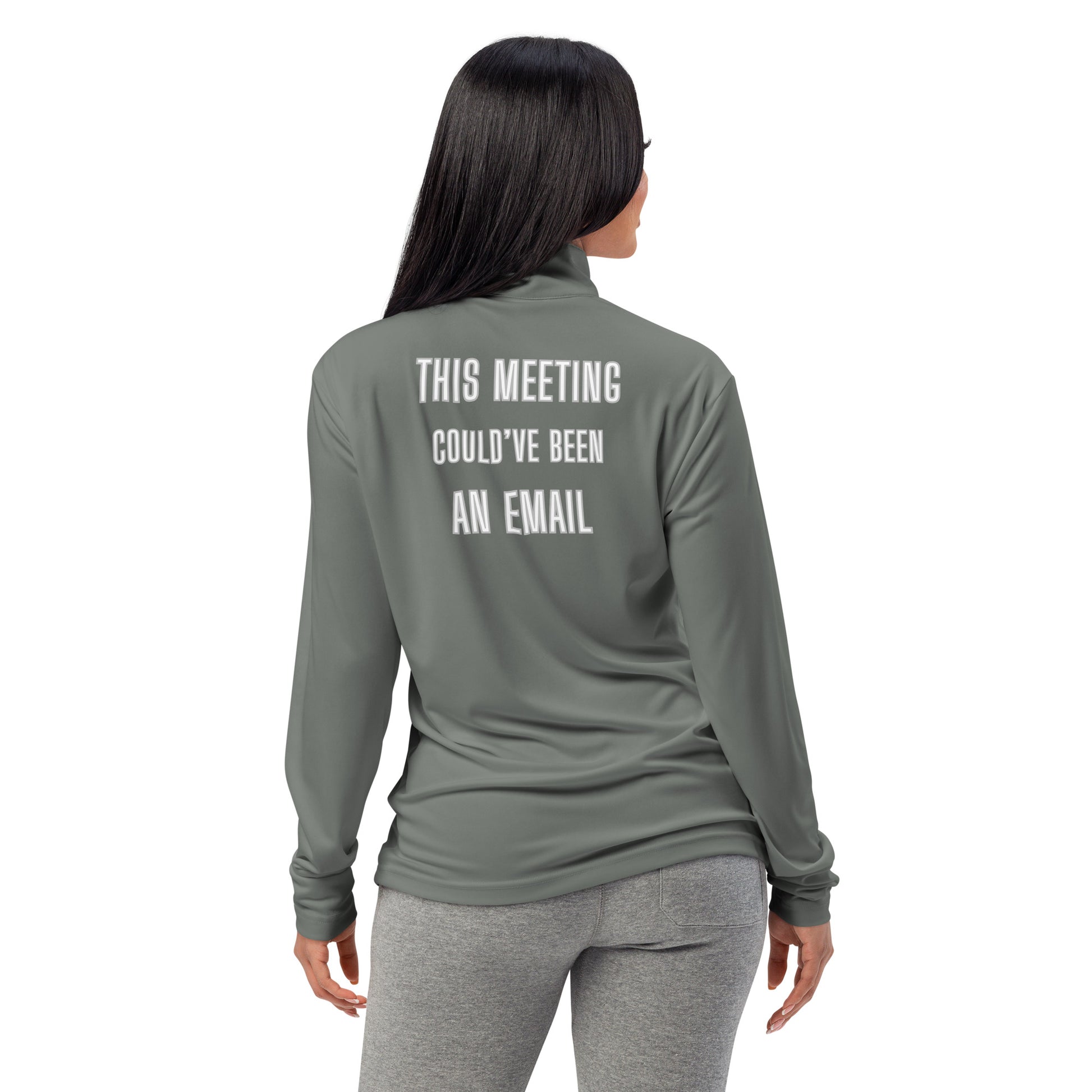 Back view on smiling woman in grey quarter-zip pullover with white "THIS MEETING COULD'VE BEEN AN EMAIL" text
