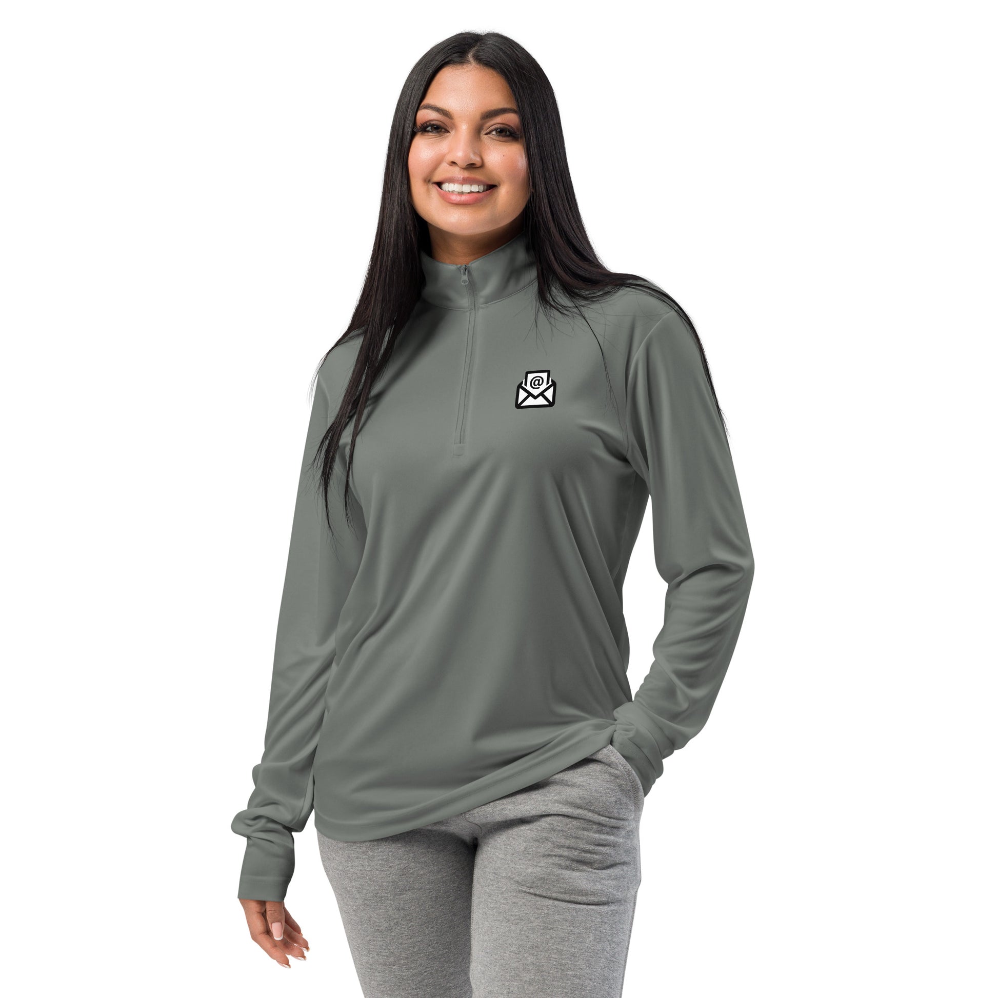 Smiling woman modeling light grey quarter-zip pullover with white email envelope icon on chest, grey pants vibe