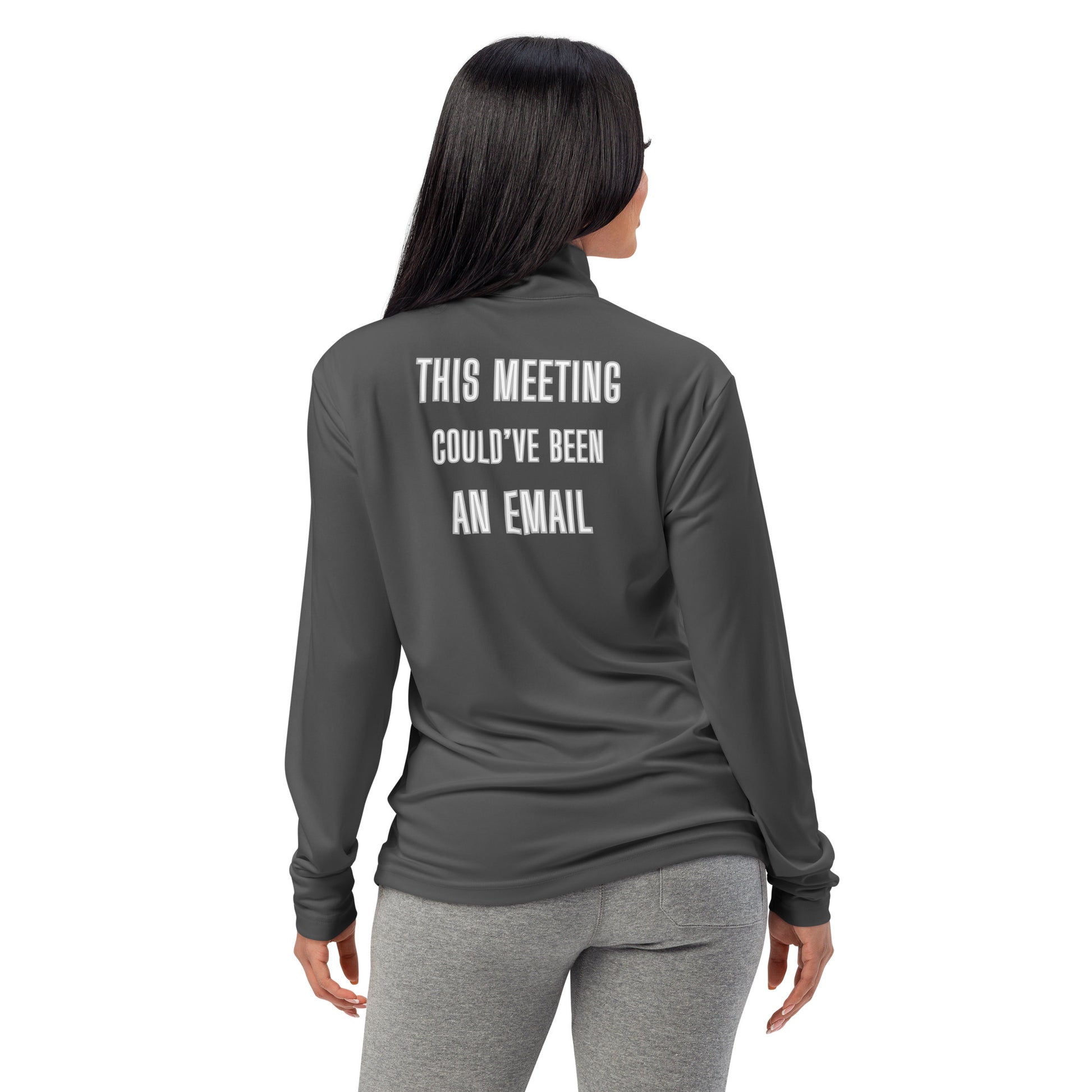 Woman from behind in dark grey quarter-zip with "THIS MEETING COULD'VE BEEN AN EMAIL" in white