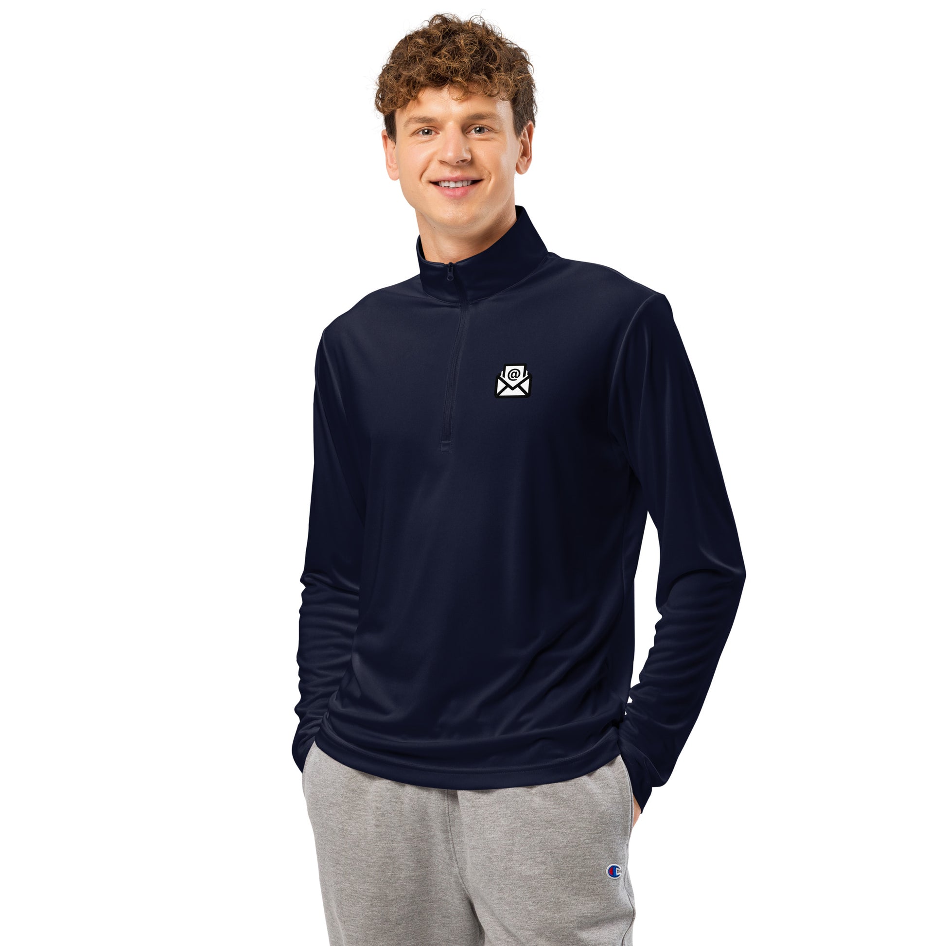 Curly-haired model front view in navy quarter-zip with white chest envelope graphic