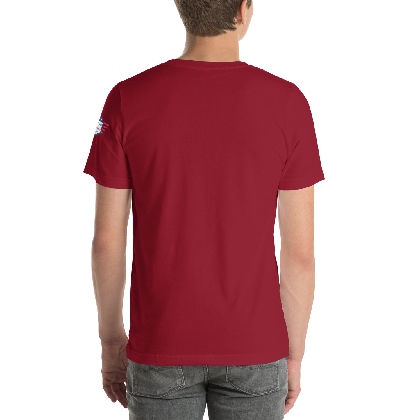 Back view of cardinal red unisex USA tee on model, plain with small sleeve patch, casual jeans vibe