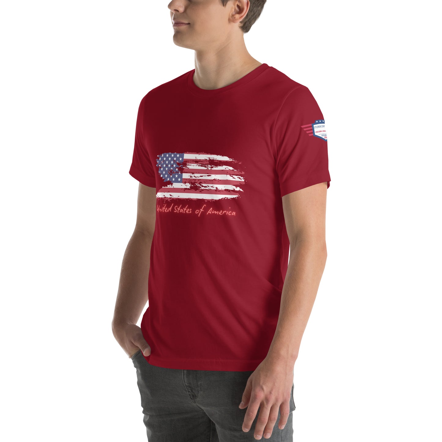 Model's left side profile in cardinal red tee showing full distressed flag front and "United States of America"