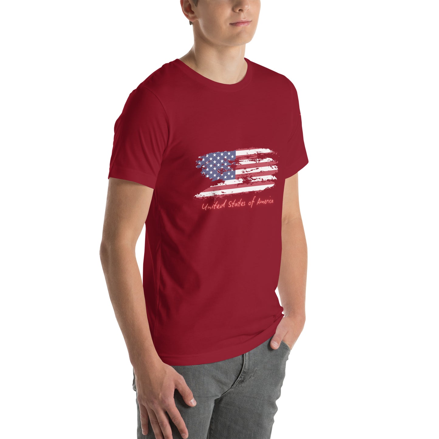 Model in 3/4 front view wearing cardinal red unisex tee with distressed USA flag splash and "United States of America" script