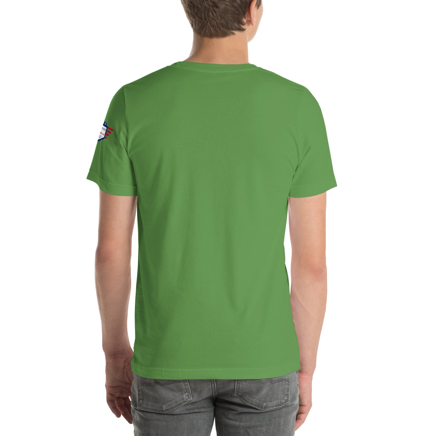 Back view of green unisex t-shirt on model, plain with small flag patch on sleeve