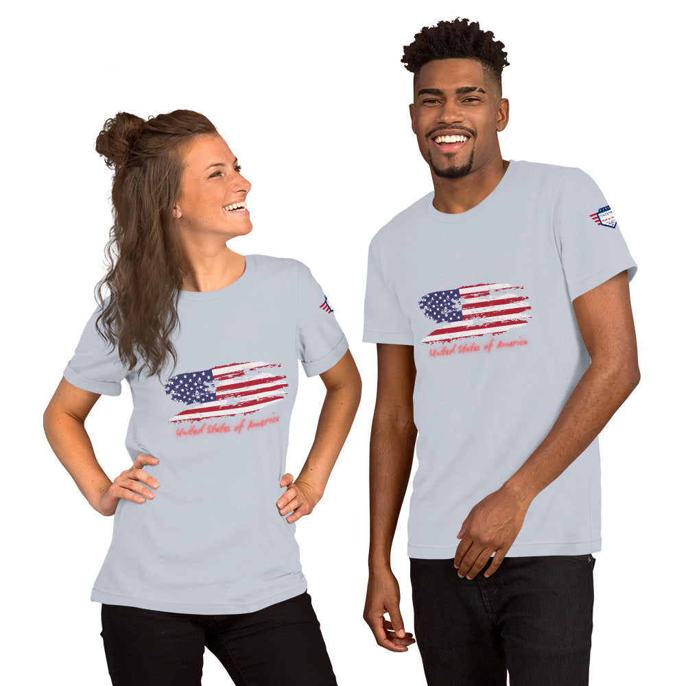 Grinning duo in heather blue USA tees showing distressed flag print, cursive "United States of America," sleeve badge