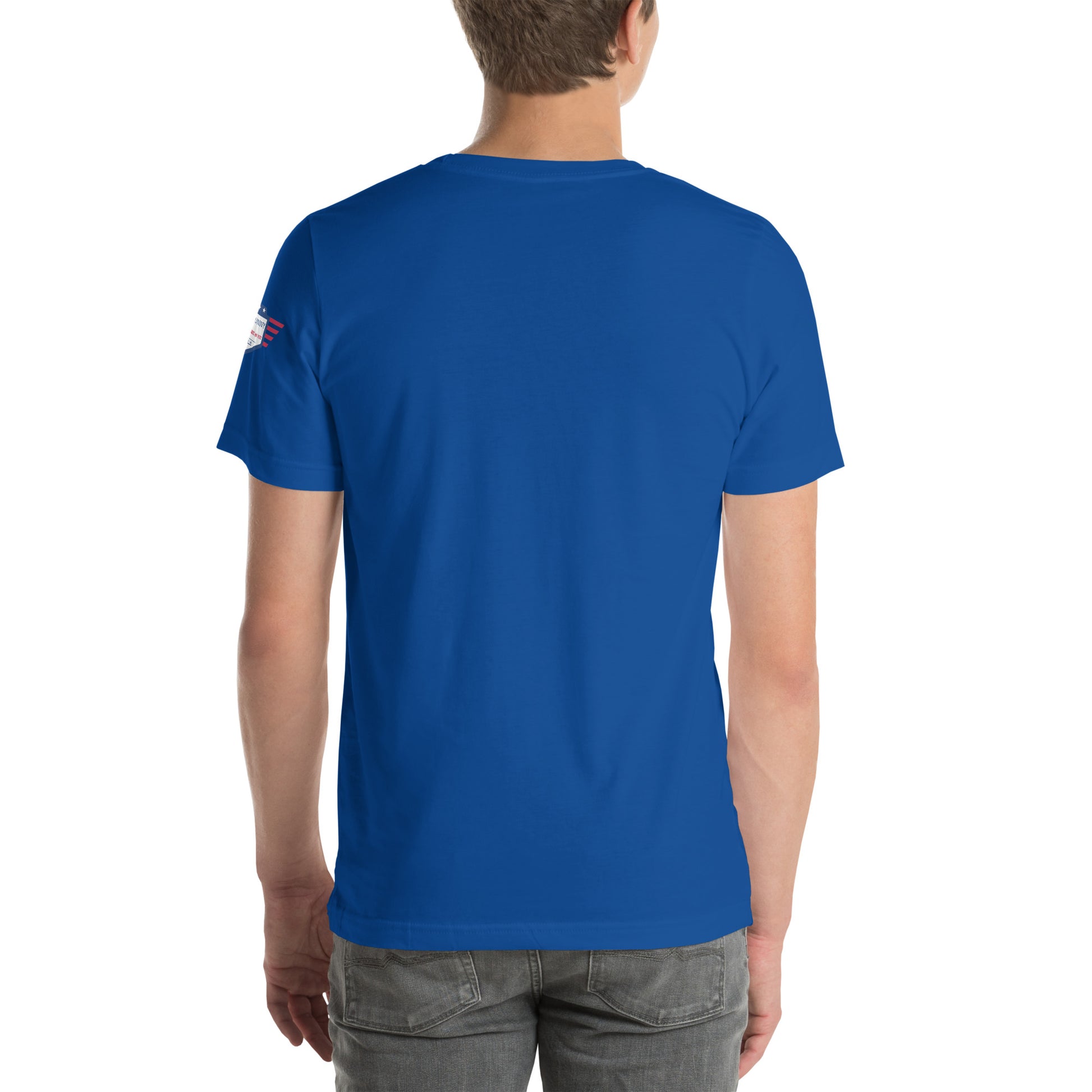 Left side profile of model in royal blue tee showing sleeve patch details