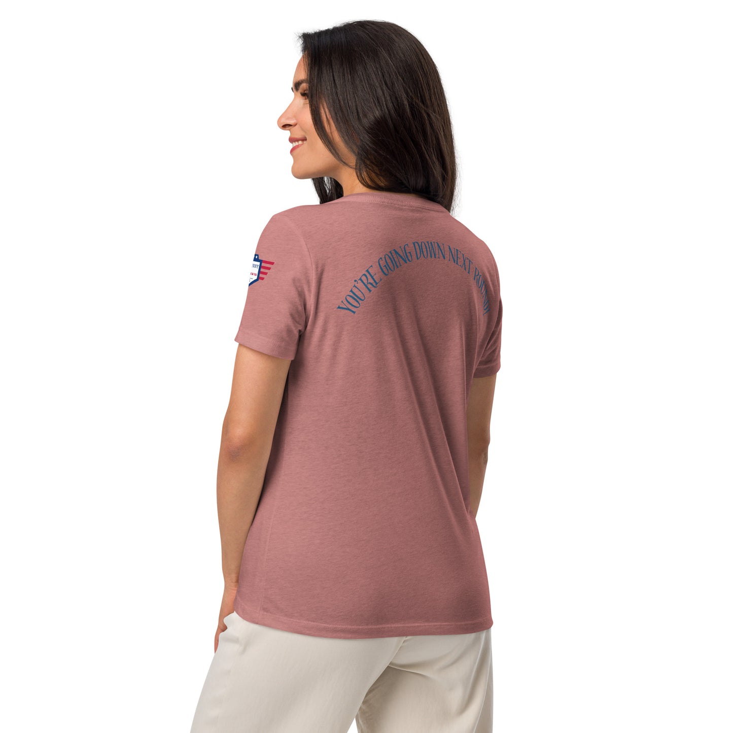 Model side-back view of white v-neck tee revealing arched "You're going down next round!" text