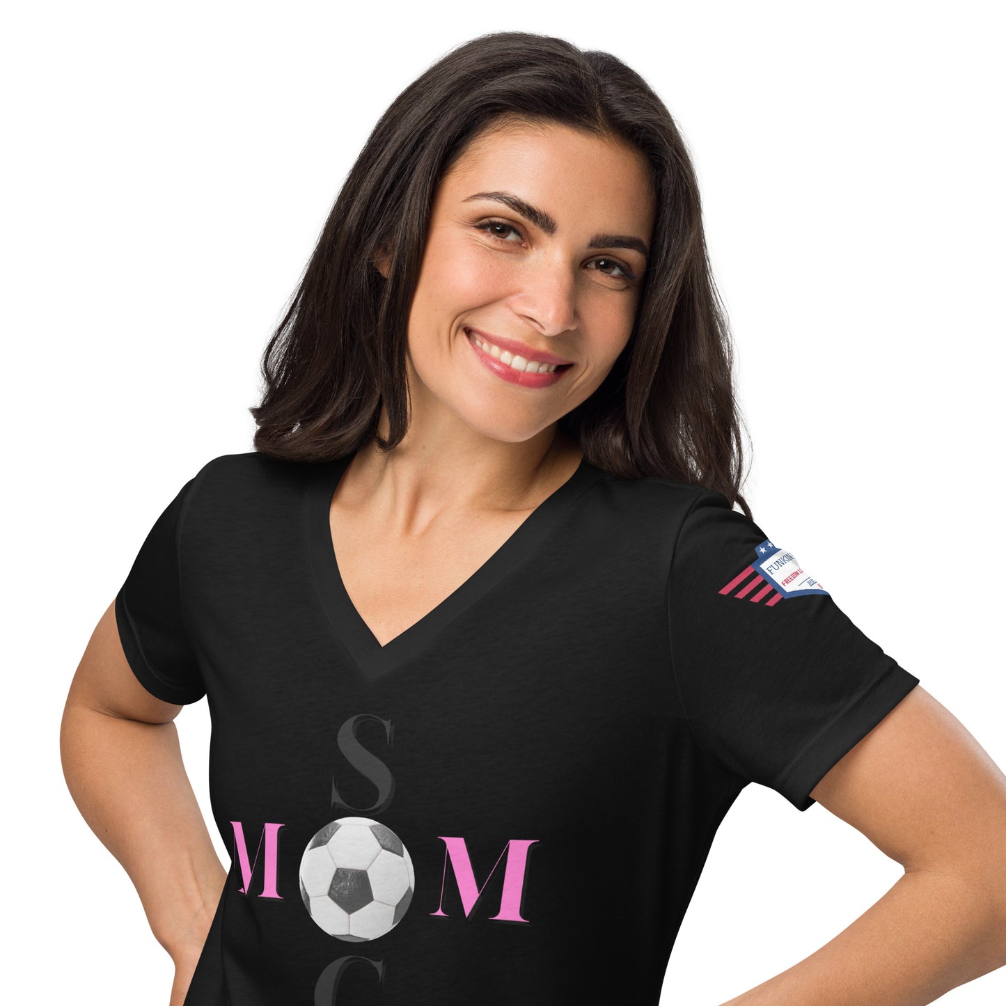 Smiling model wearing black v-neck t-shirt showing pink "MOM" soccer ball and partial SOCCER text, flag patch