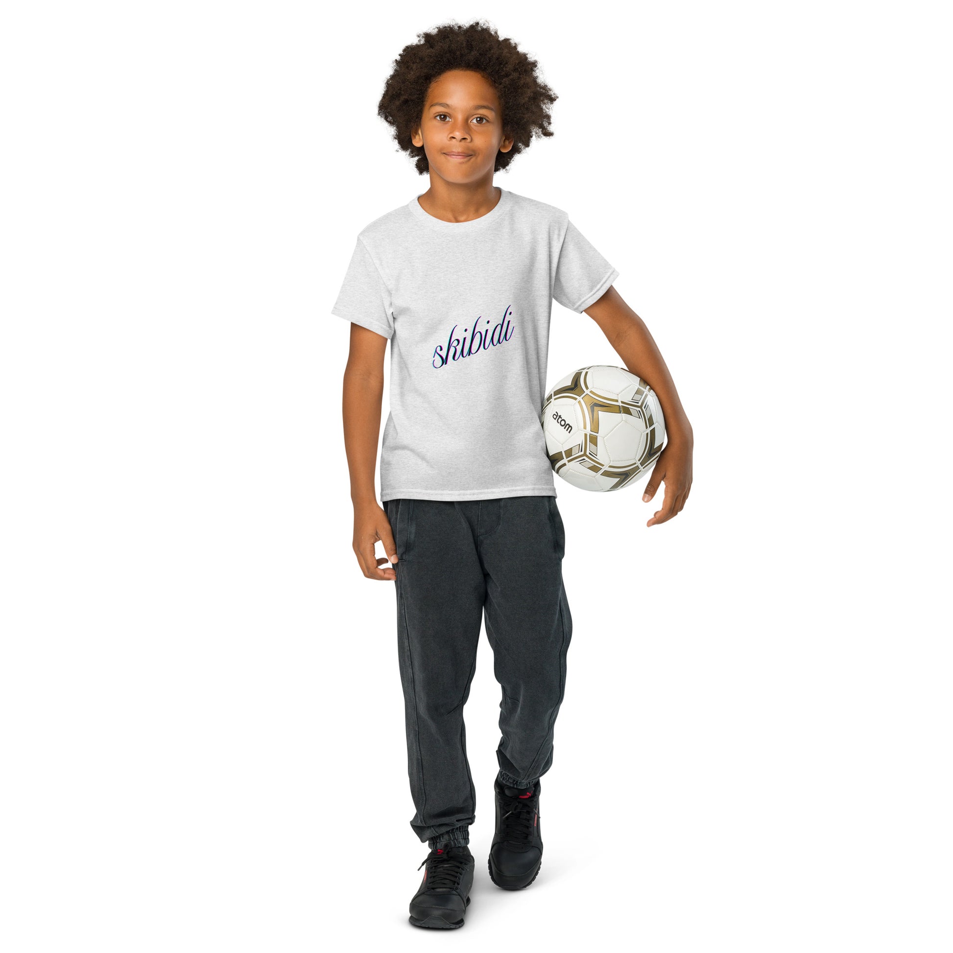 Kid holding soccer ball, front navy "skibidi" cursive on off-white youth t-shirt