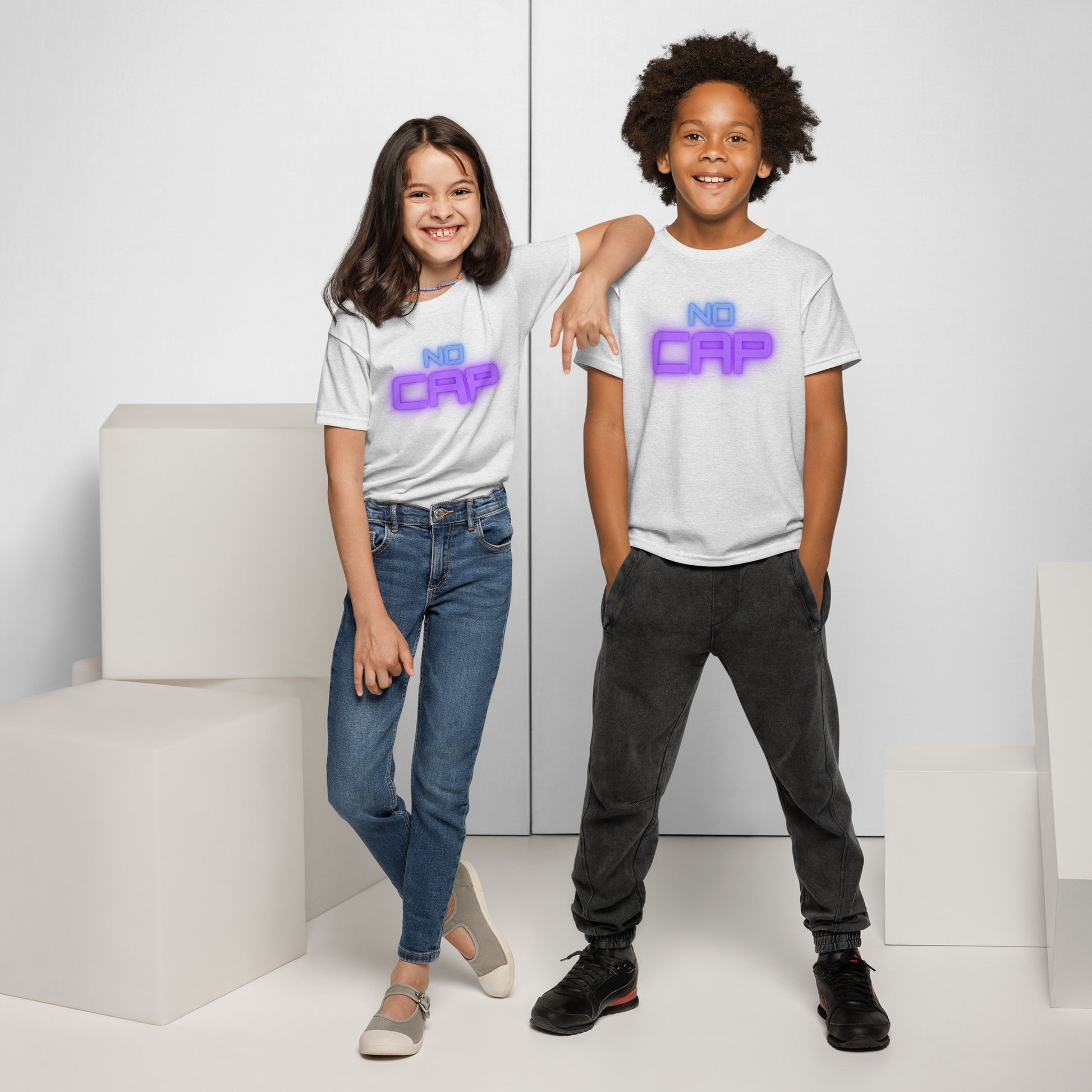 Two smiling kids modeling front view of white youth "NO CAP" tees in neon blue-purple glow font, truth vibes only