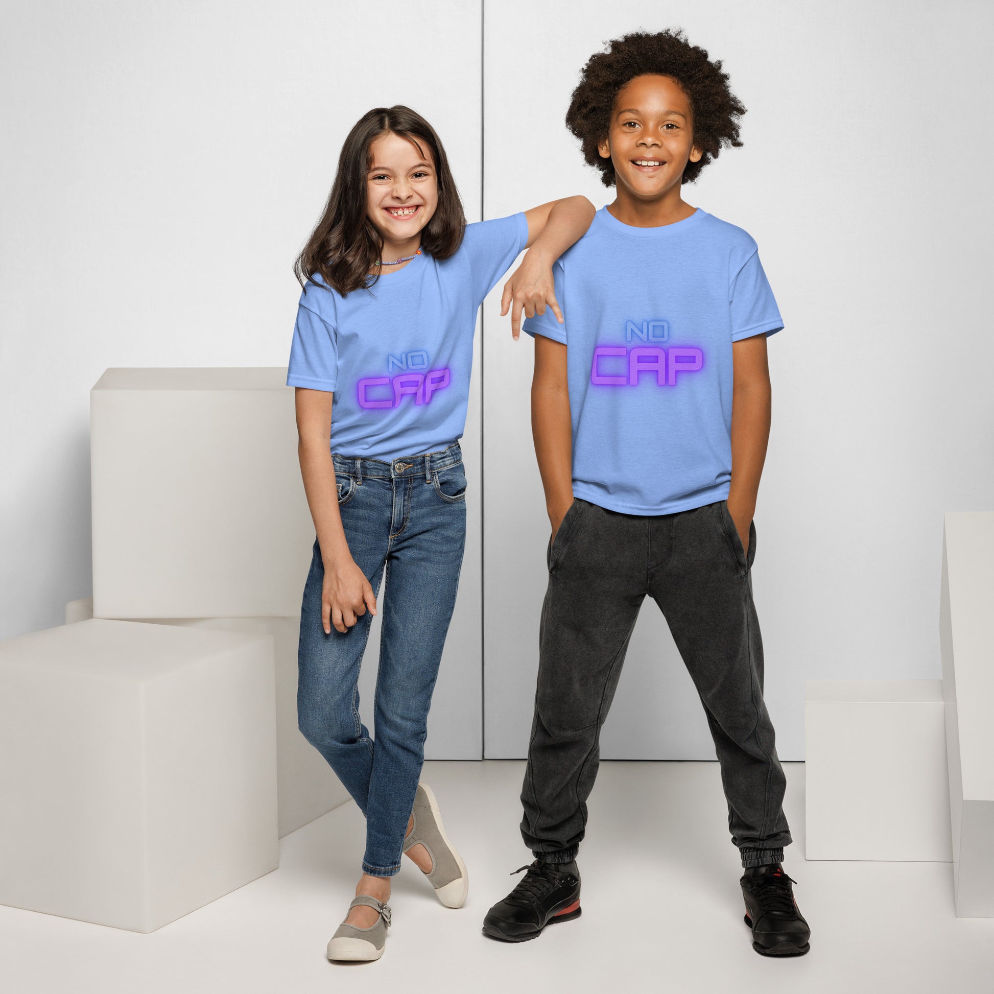 Smiling kids duo rocking Carolina blue "No Cap" neon tee front view, arms linked, playful pose on white backdrop