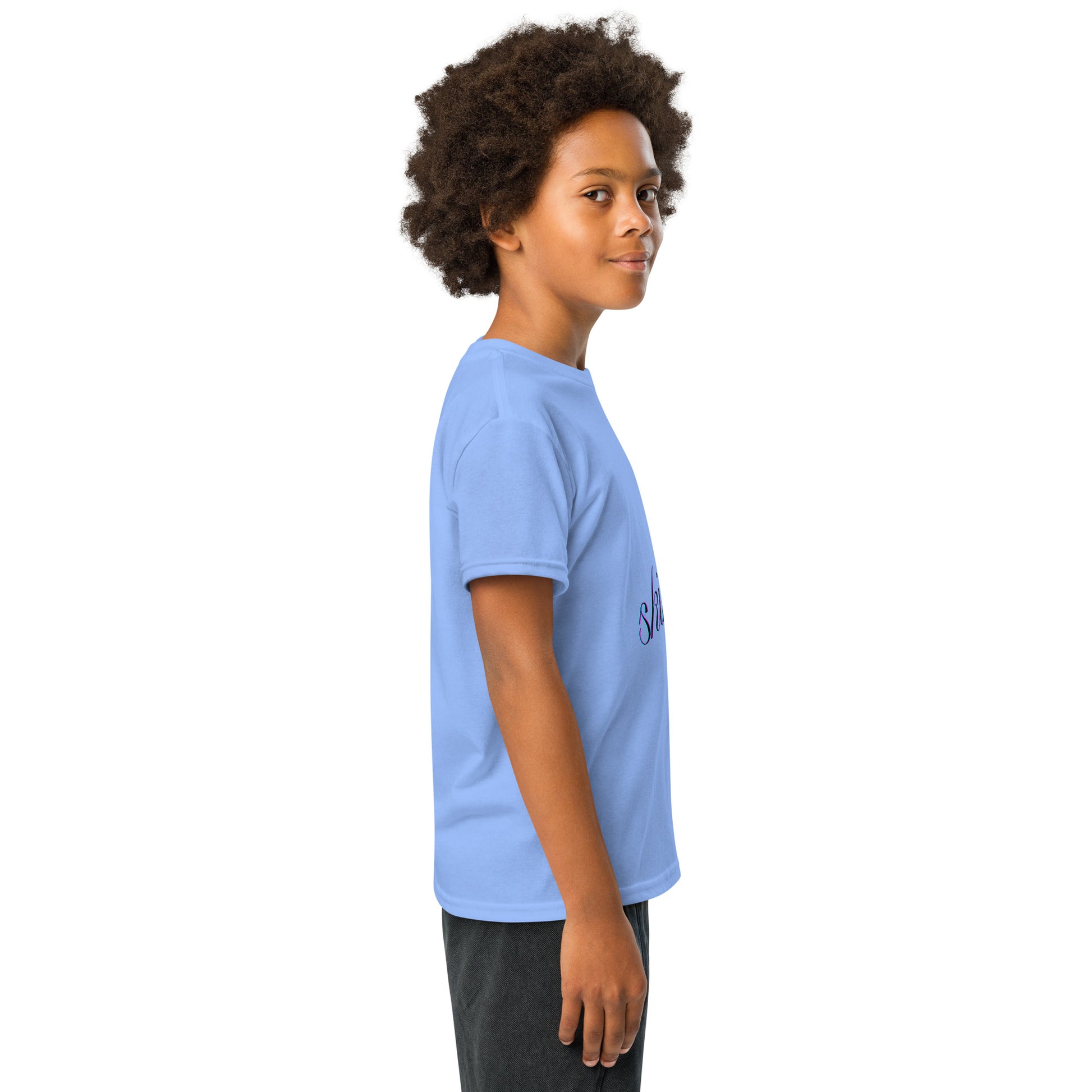 Kid model 3/4 side view in Carolina blue skibidi youth t-shirt, navy cursive "skibidi" curving across chest