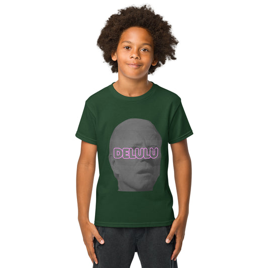Young boy models front of forest green Delulu youth t-shirt, pink "DELULU" over gray face graphic