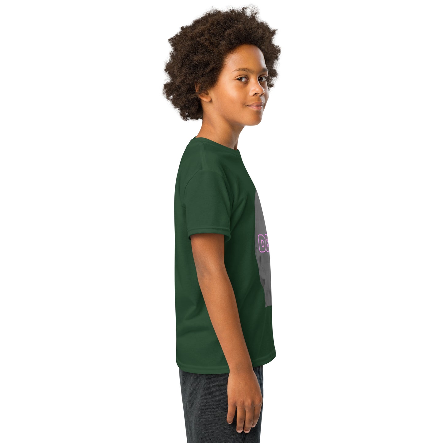Angled side view of boy wearing forest green Delulu youth t-shirt showing pink "DELU" on gray face