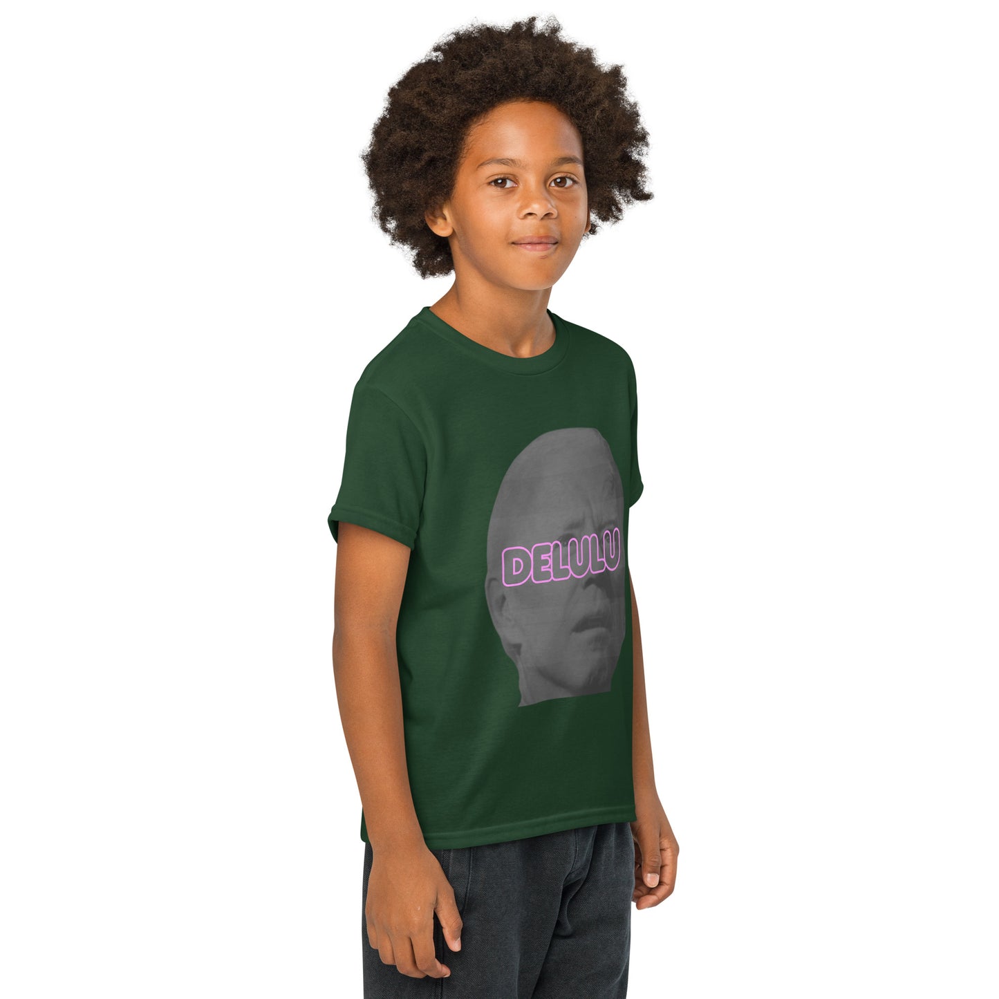 Front-leaning side view of smiling boy in forest green Delulu t-shirt with pink "DELULU" gray face print