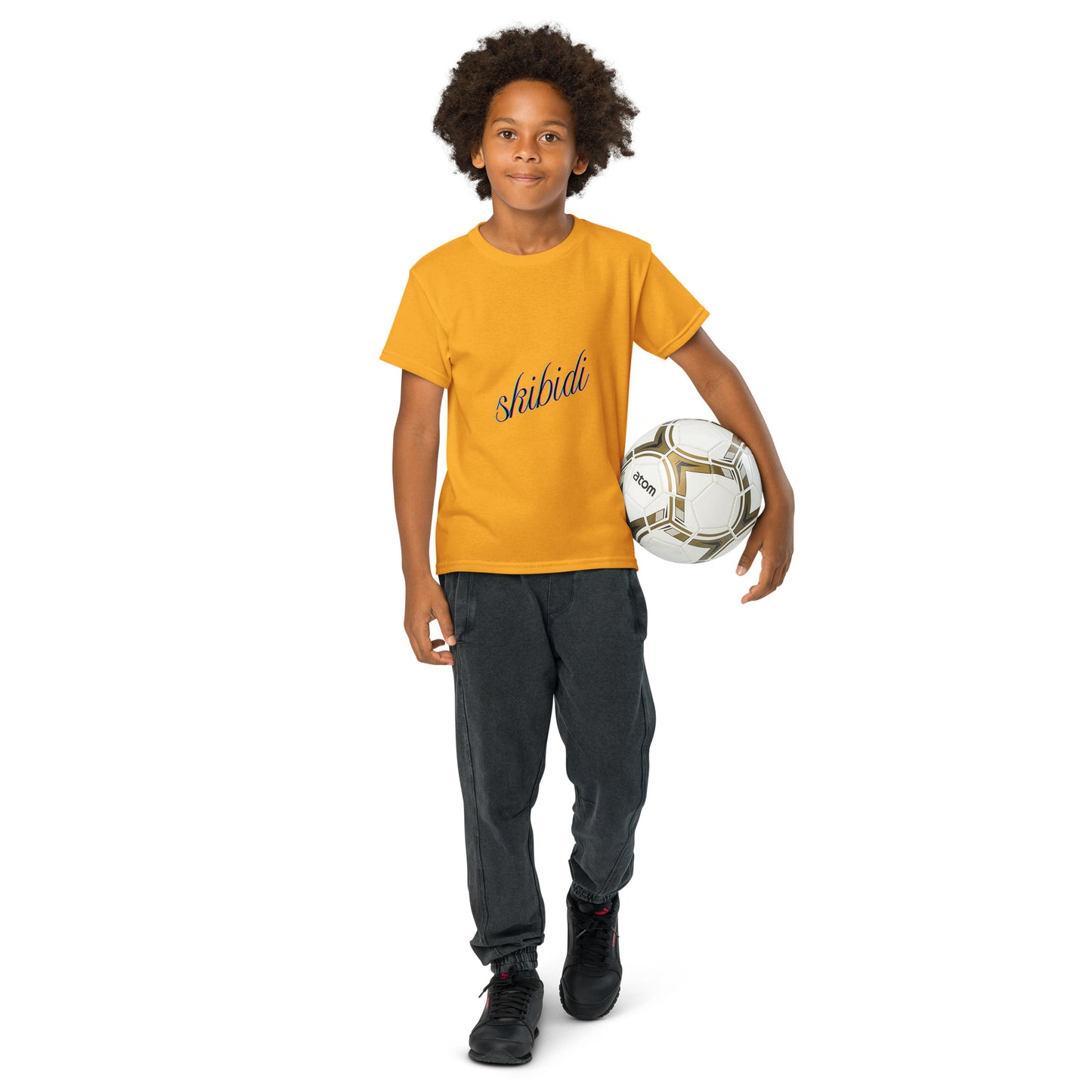 Kid rocking gold skibidi youth t-shirt front view, navy script, soccer ball in hand