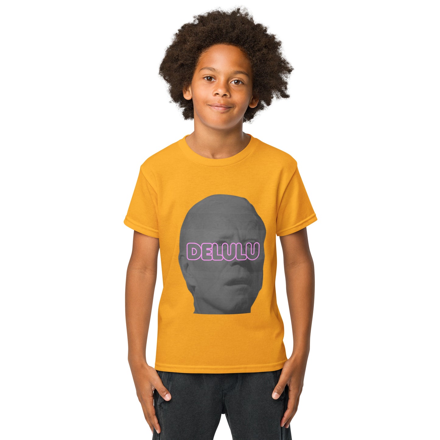 Front view of kid in gold Delulu youth tee, gray face with pink neon "DELULU" print