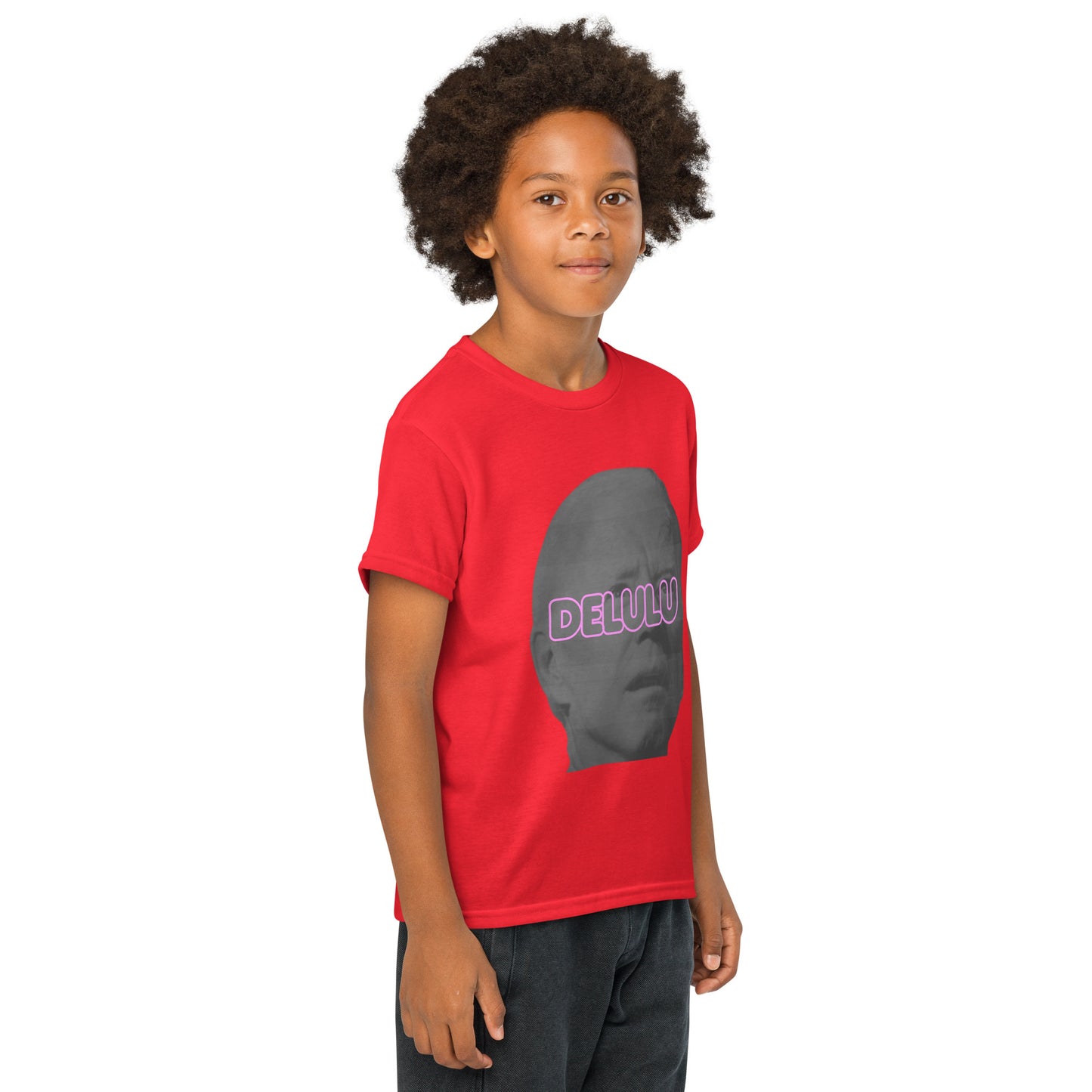 Front-tilted side view of boy in red Delulu youth tee, pink "DELULU" over gray face design