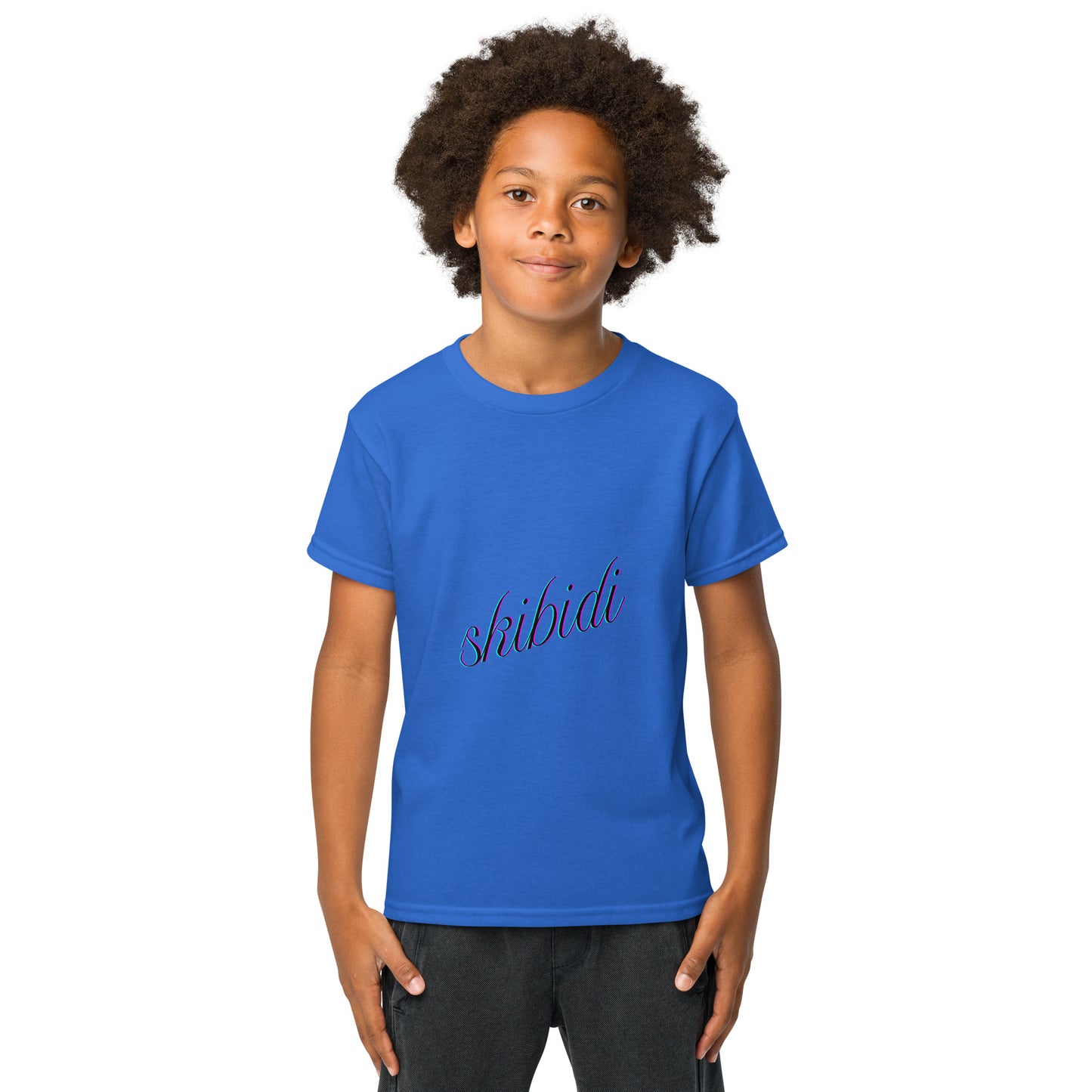 Smiling kid rocking front view of Carolina blue youth tee with cursive "skibidi" print, hands in pockets